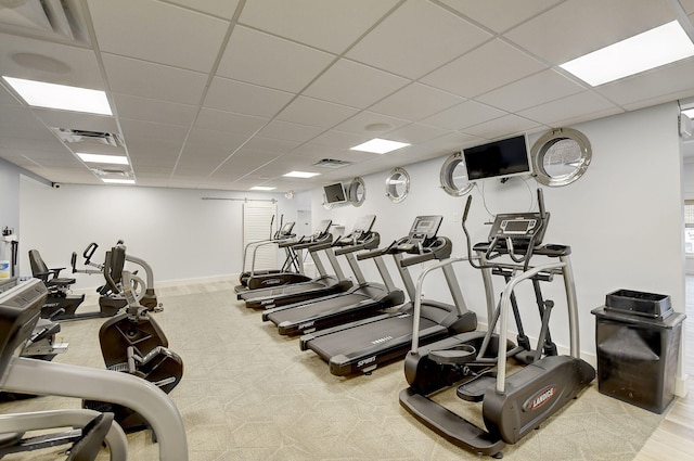 workout area with a paneled ceiling and carpet flooring