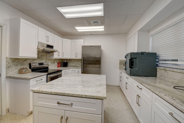 kitchen with appliances with stainless steel finishes, white cabinets, and decorative backsplash