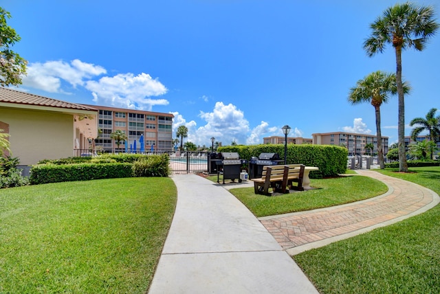 surrounding community featuring a swimming pool and a yard