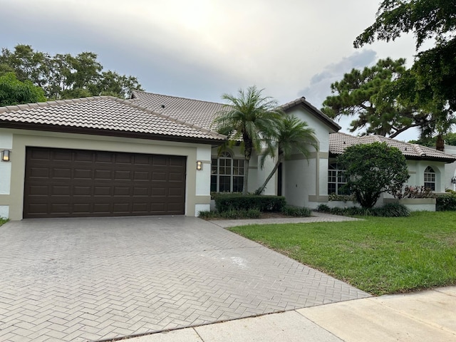 view of front of home featuring a garage and a front lawn