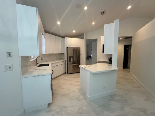 kitchen featuring light tile patterned flooring, white cabinetry, vaulted ceiling, decorative backsplash, and high end refrigerator