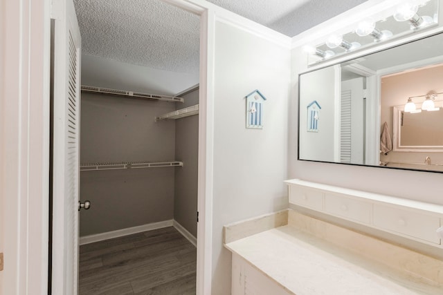 bathroom featuring hardwood / wood-style flooring and a textured ceiling