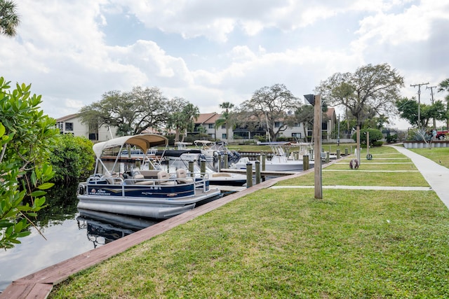 view of dock featuring a water view and a yard