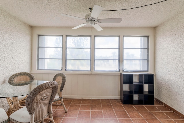 tiled home office featuring a textured ceiling and ceiling fan