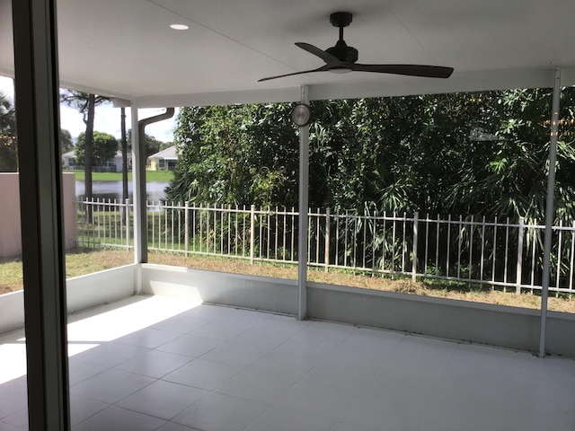 view of patio / terrace featuring a water view and ceiling fan