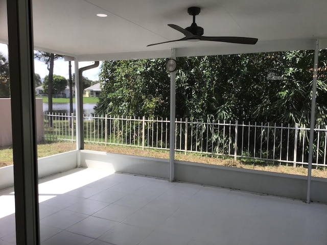 7504 SE Marsh Fern Ln, Hobe Sound, FL 33455 - unfurnished sunroom featuring ceiling fan, a water view, and plenty of natural light