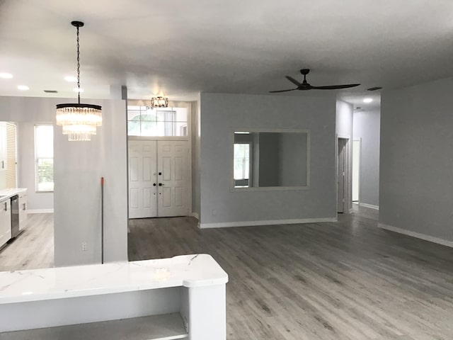 7504 SE Marsh Fern Ln, Hobe Sound, FL 33455 - entryway featuring a chandelier, wood finished floors, baseboards, a ceiling fan, and recessed lighting
