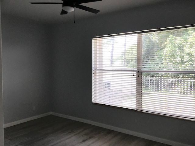 spare room with dark hardwood / wood-style floors, plenty of natural light, and ceiling fan