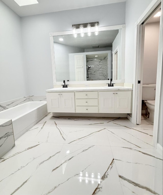 7504 SE Marsh Fern Ln, Hobe Sound, FL 33455 - bathroom with marble look tiles, double vanity, toilet, and a bath