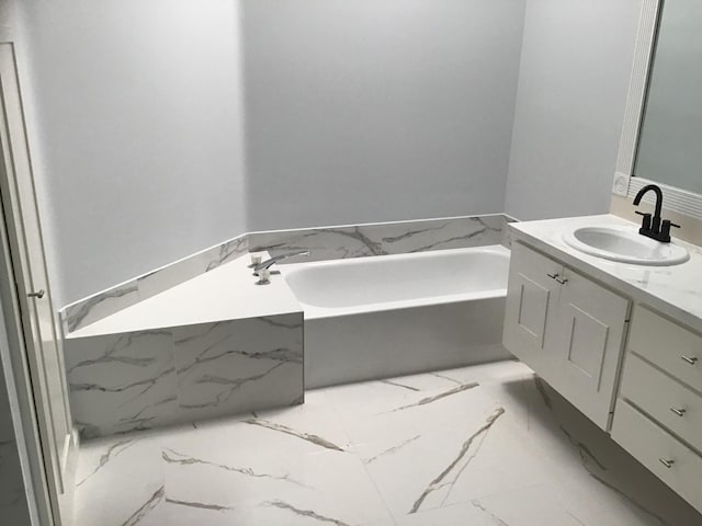 7504 SE Marsh Fern Ln, Hobe Sound, FL 33455 - bathroom with marble tiled floors, vanity, and a bath