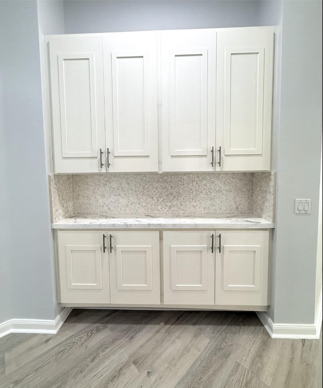 interior details with hardwood / wood-style flooring and decorative backsplash