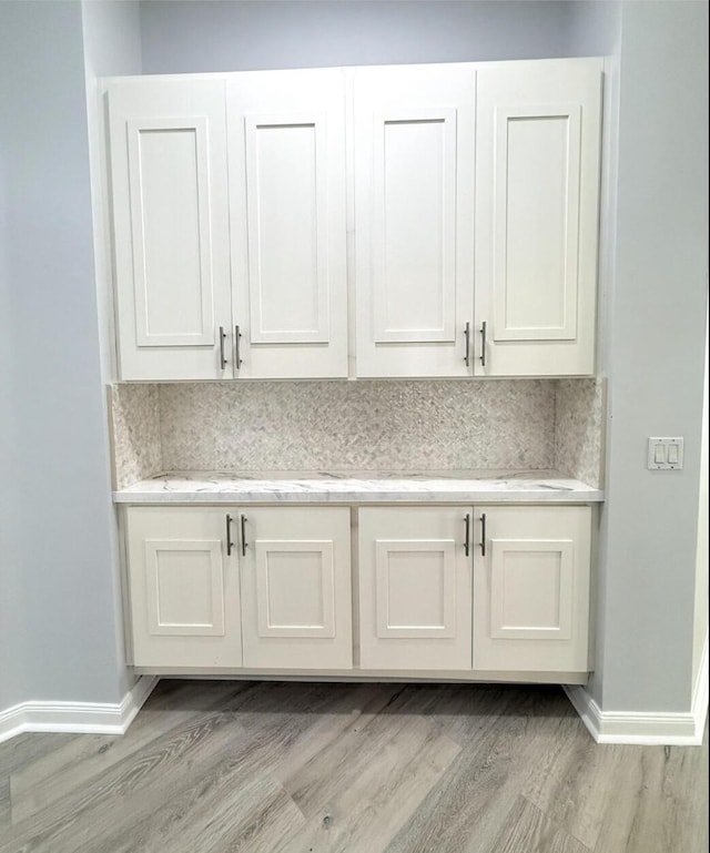 7504 SE Marsh Fern Ln, Hobe Sound, FL 33455 - detailed view of wood finished floors and baseboards