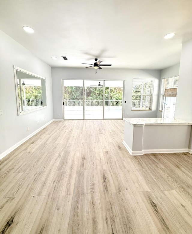 7504 SE Marsh Fern Ln, Hobe Sound, FL 33455 - unfurnished living room with ceiling fan, baseboards, light wood-style flooring, and recessed lighting
