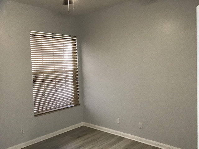 7504 SE Marsh Fern Ln, Hobe Sound, FL 33455 - empty room with dark wood finished floors, baseboards, and ceiling fan