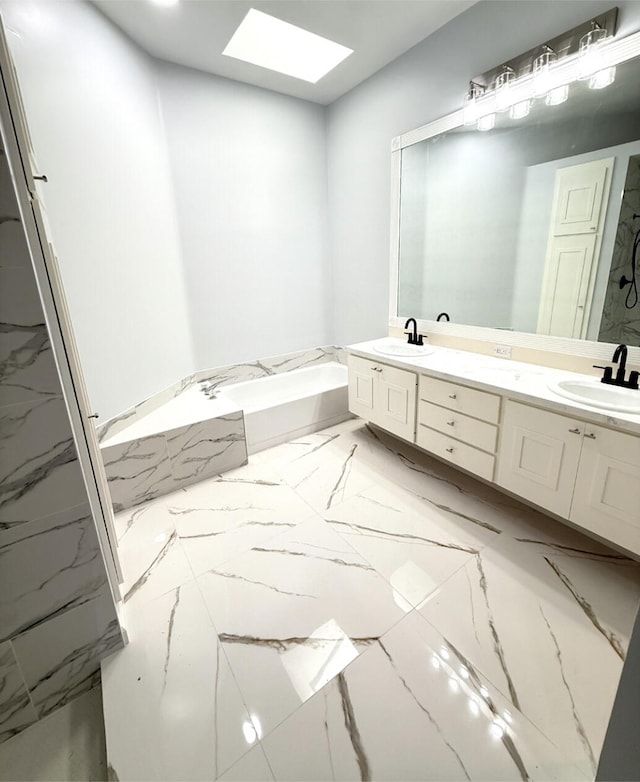 bathroom with vanity, independent shower and bath, and a skylight