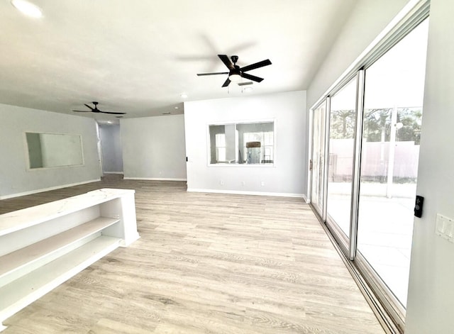 interior space featuring light hardwood / wood-style flooring and ceiling fan