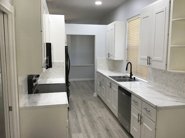 kitchen with white cabinets, dishwasher, light hardwood / wood-style floors, and sink