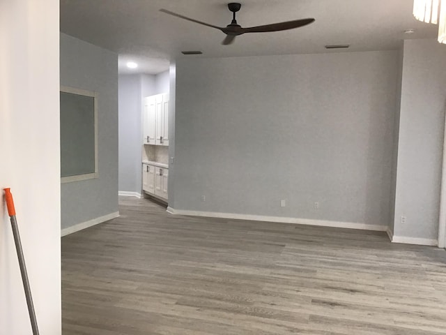 7504 SE Marsh Fern Ln, Hobe Sound, FL 33455 - spare room featuring ceiling fan, wood finished floors, and baseboards