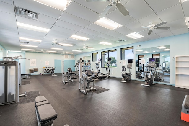 workout area with ceiling fan and a drop ceiling