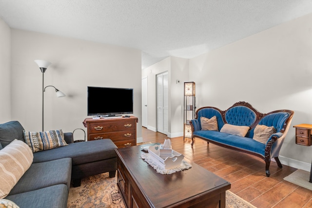 living room with a textured ceiling and hardwood / wood-style flooring