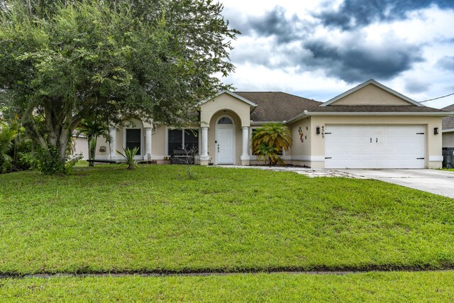 single story home featuring a garage and a front lawn