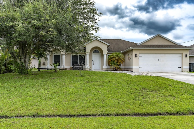 view of front of property featuring an attached garage, driveway, a front yard, and stucco siding