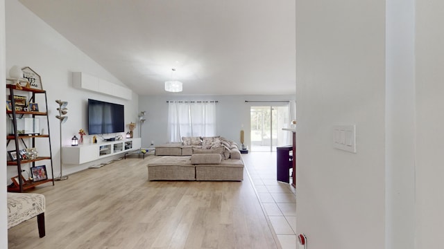 living area featuring light wood-style floors and vaulted ceiling