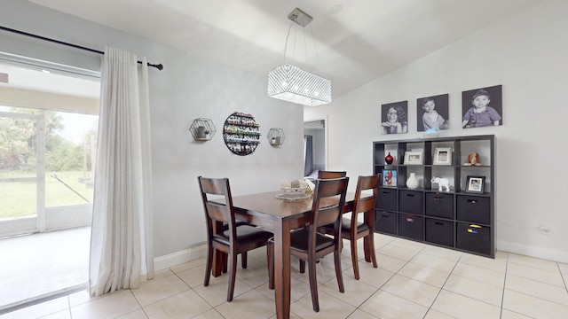 dining space with baseboards and tile patterned floors