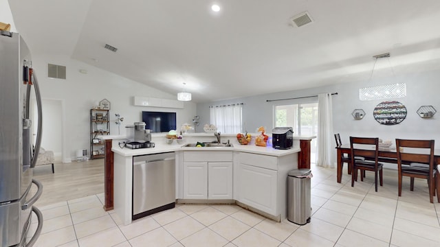 kitchen with visible vents, white cabinets, open floor plan, stainless steel appliances, and light countertops