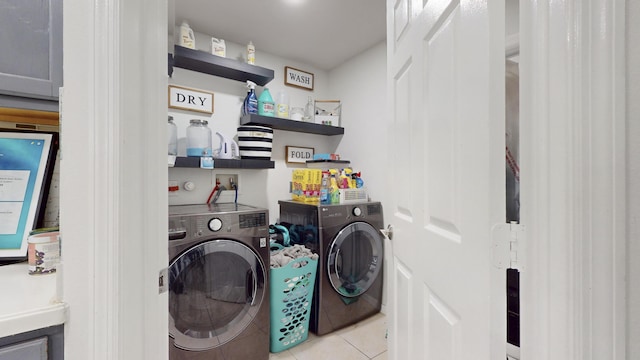 laundry room with light tile patterned floors, laundry area, and washer and dryer