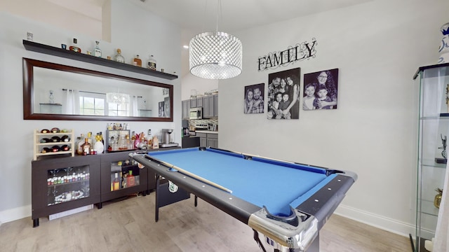 rec room with a dry bar, light wood-type flooring, billiards, and baseboards