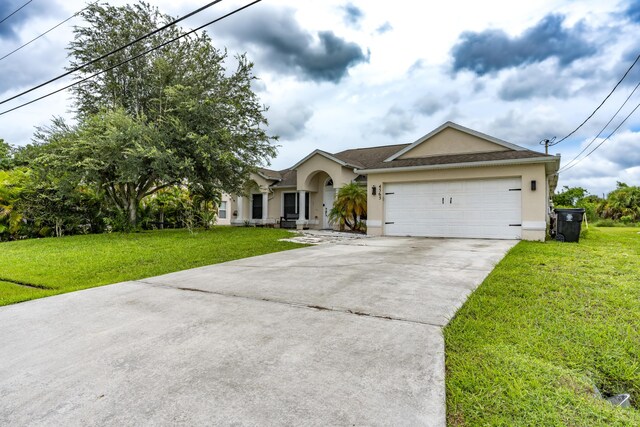 ranch-style home with a garage and a front yard