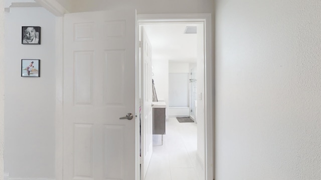 hallway with light tile patterned floors and visible vents