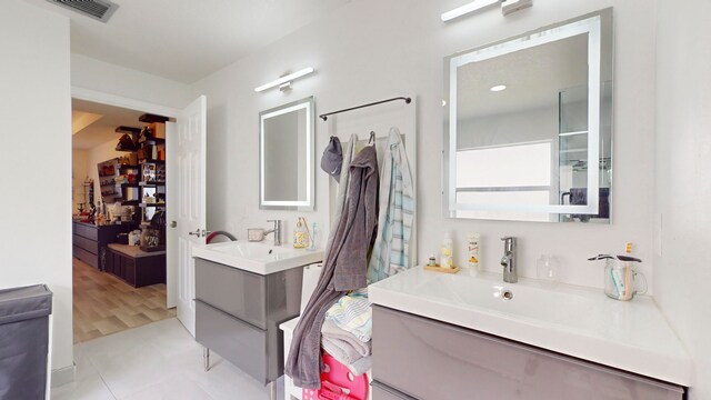 bathroom with wood-type flooring and double sink vanity