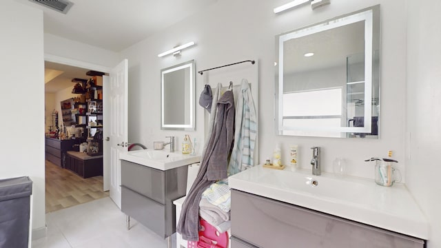 bathroom featuring a sink, visible vents, and two vanities