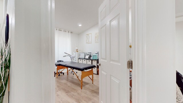 interior space featuring lofted ceiling and light hardwood / wood-style floors