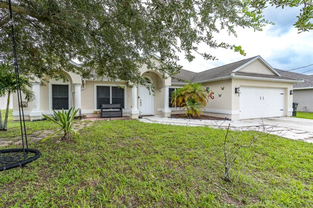 single story home featuring a garage and a front lawn