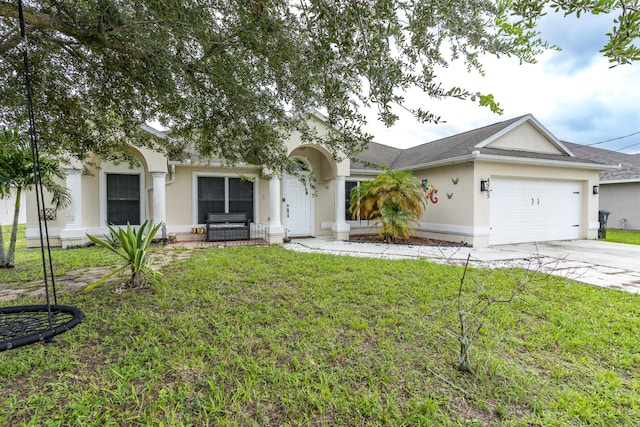 view of front of home featuring driveway, an attached garage, a front lawn, and stucco siding