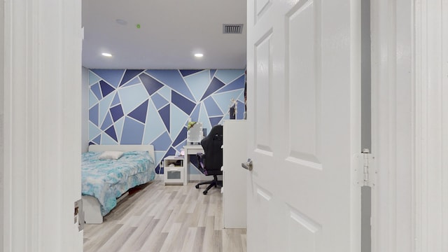 bedroom featuring recessed lighting, an accent wall, visible vents, light wood-type flooring, and wallpapered walls