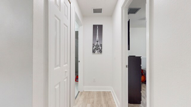 corridor with light hardwood / wood-style flooring