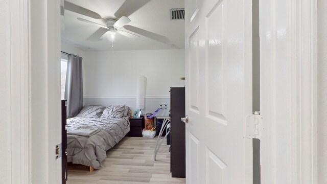 bedroom with ceiling fan and light wood-type flooring