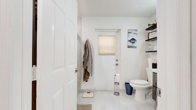 bathroom with tile patterned flooring and toilet