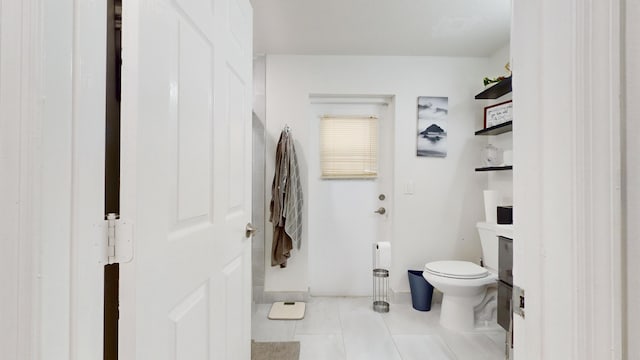 bathroom with toilet and tile patterned floors