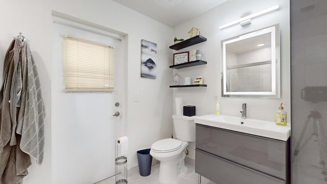 bathroom featuring toilet, an enclosed shower, and vanity