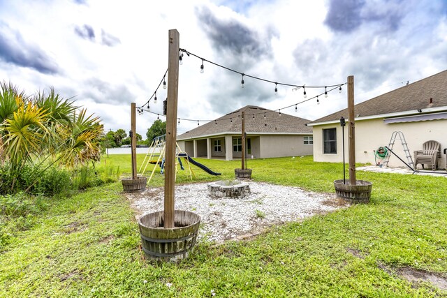 view of yard with an outdoor fire pit