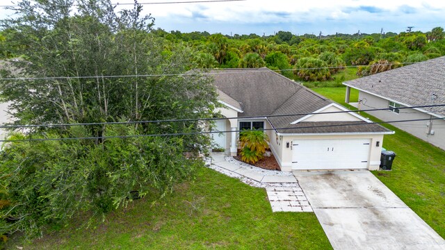 view of front of property featuring a garage and a front lawn