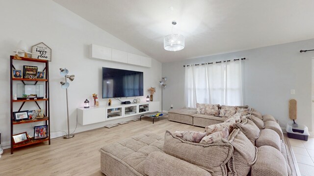 living room featuring light hardwood / wood-style floors and vaulted ceiling