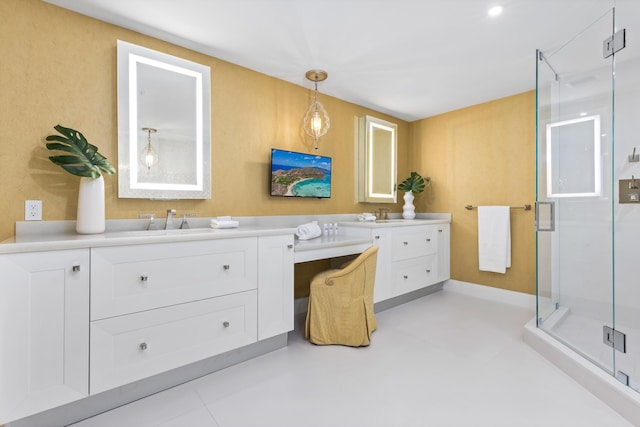 bathroom featuring a shower with shower door, vanity, and tile patterned floors