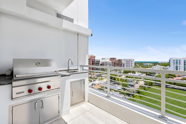 view of patio with a balcony, an outdoor kitchen, and a grill