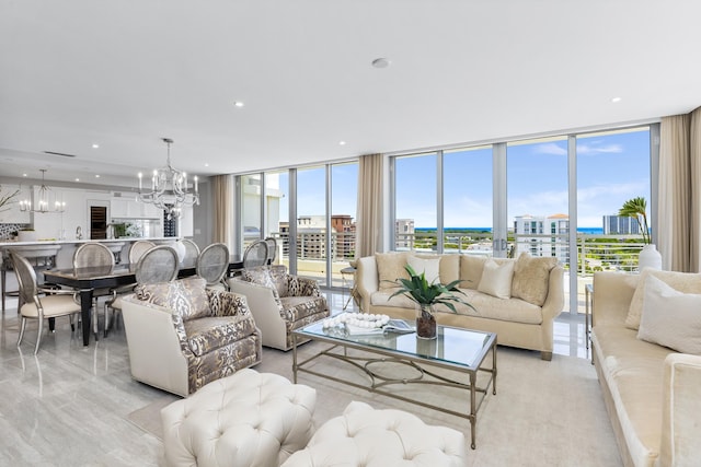 living room with a chandelier and floor to ceiling windows